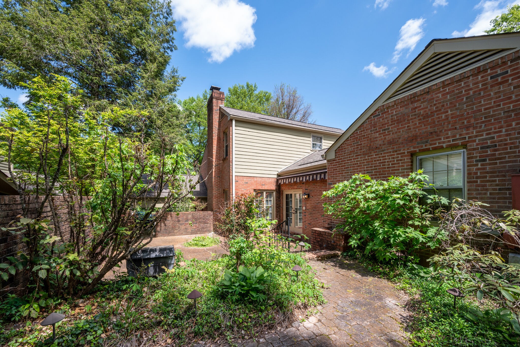 3704 Estes Road, Unit E Nashville, TN 37215 - Photo 26 of 27 a backyard of a house with plants and large tree