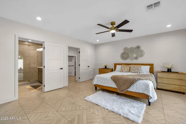 a living room with furniture and a refrigerator