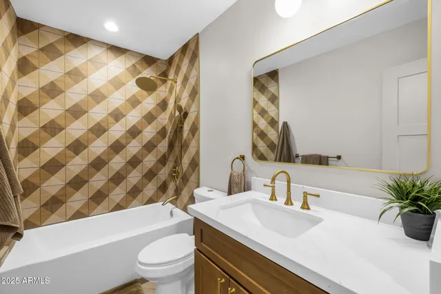 a bathroom with a sink a toilet a mirror and shower curtain