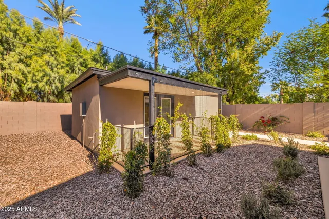a view of a house with backyard and sitting area
