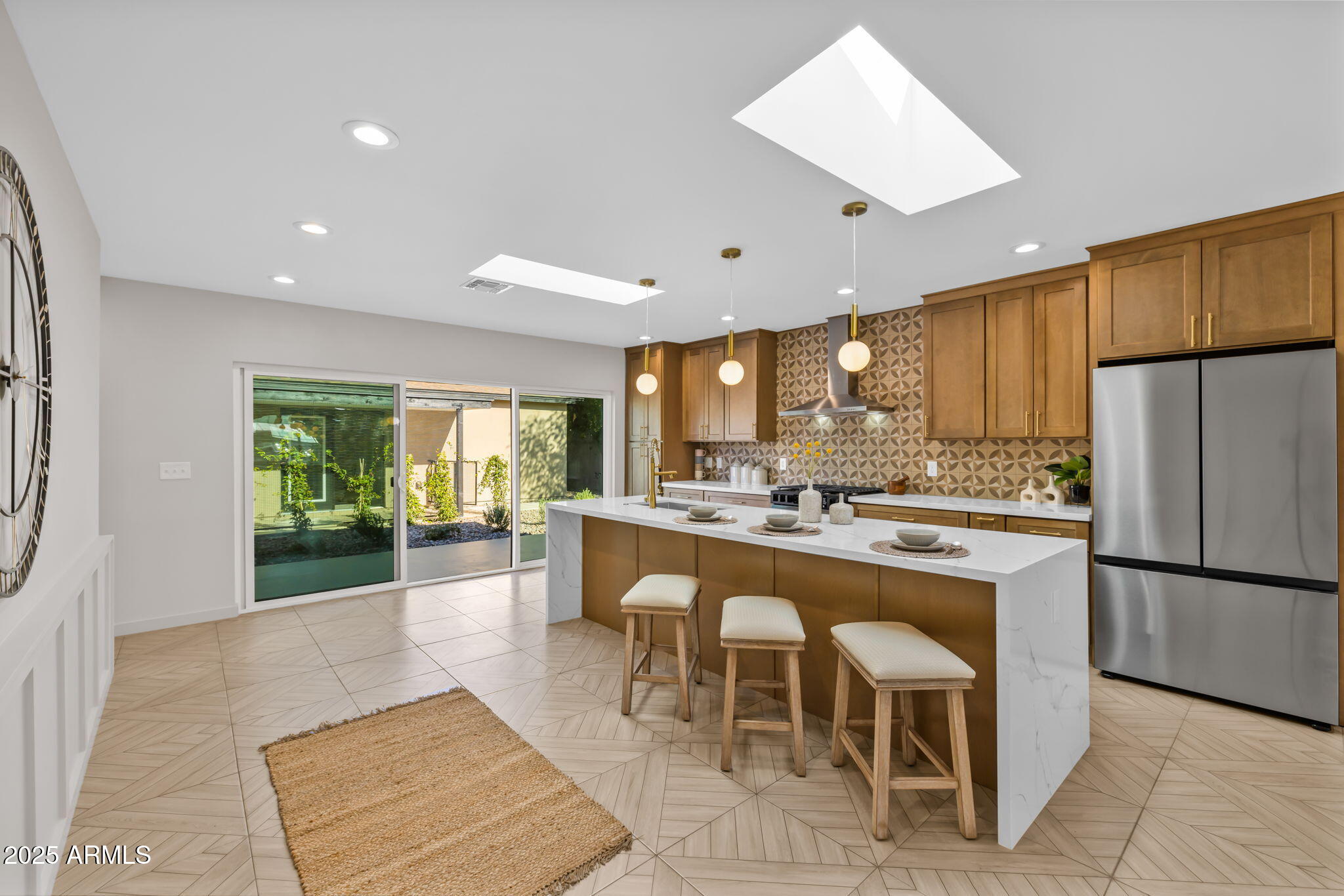 1540 East Cheery Lynn Road Phoenix, AZ 85014 - Photo 7 of 46 a large kitchen with kitchen island a island a stove a refrigerator and a dining table