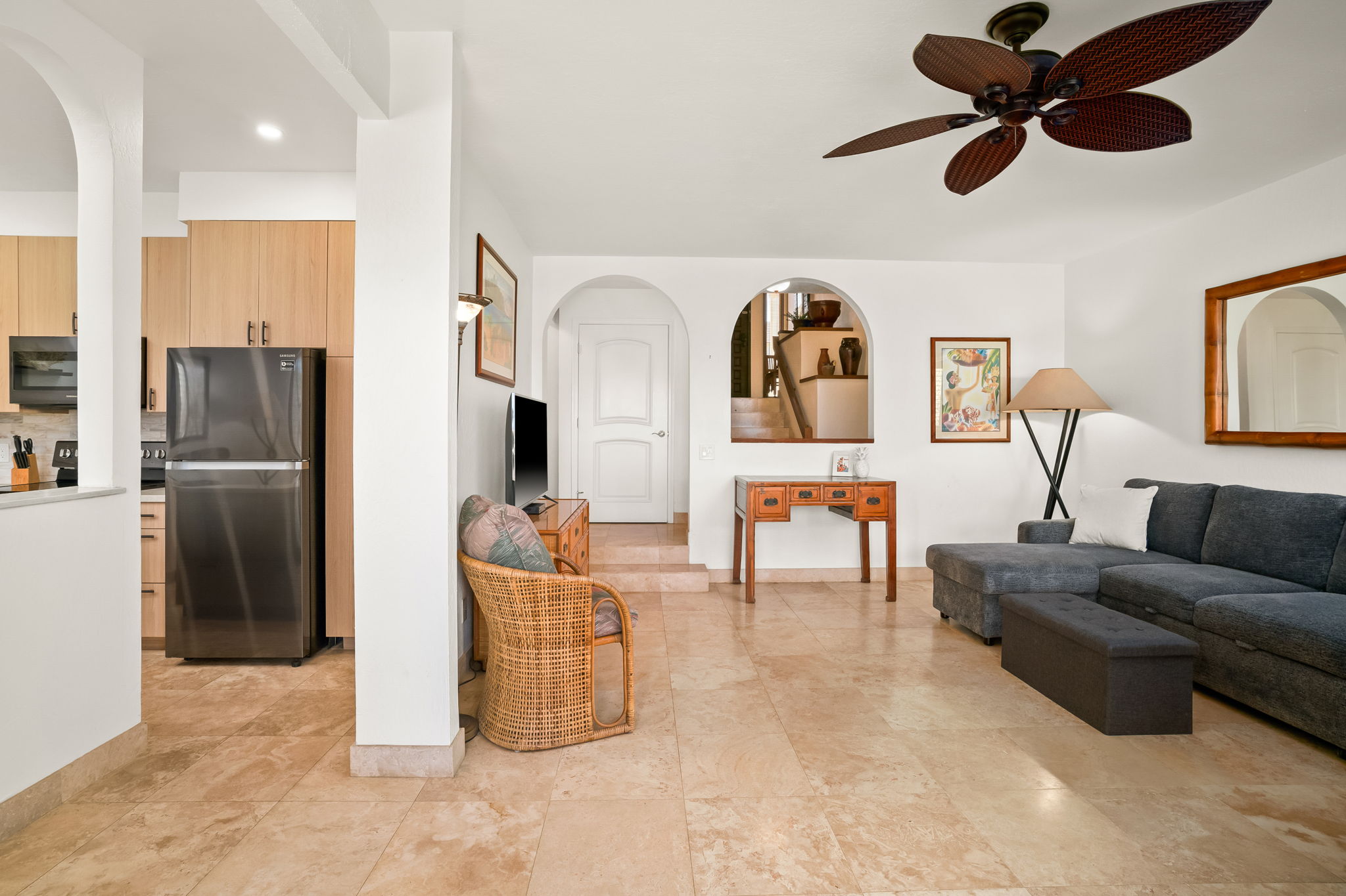 1901 Poipu Road, Unit 212 Koloa, HI 96756 - Photo 12 of 30 a living room with furniture a refrigerator and a chandelier