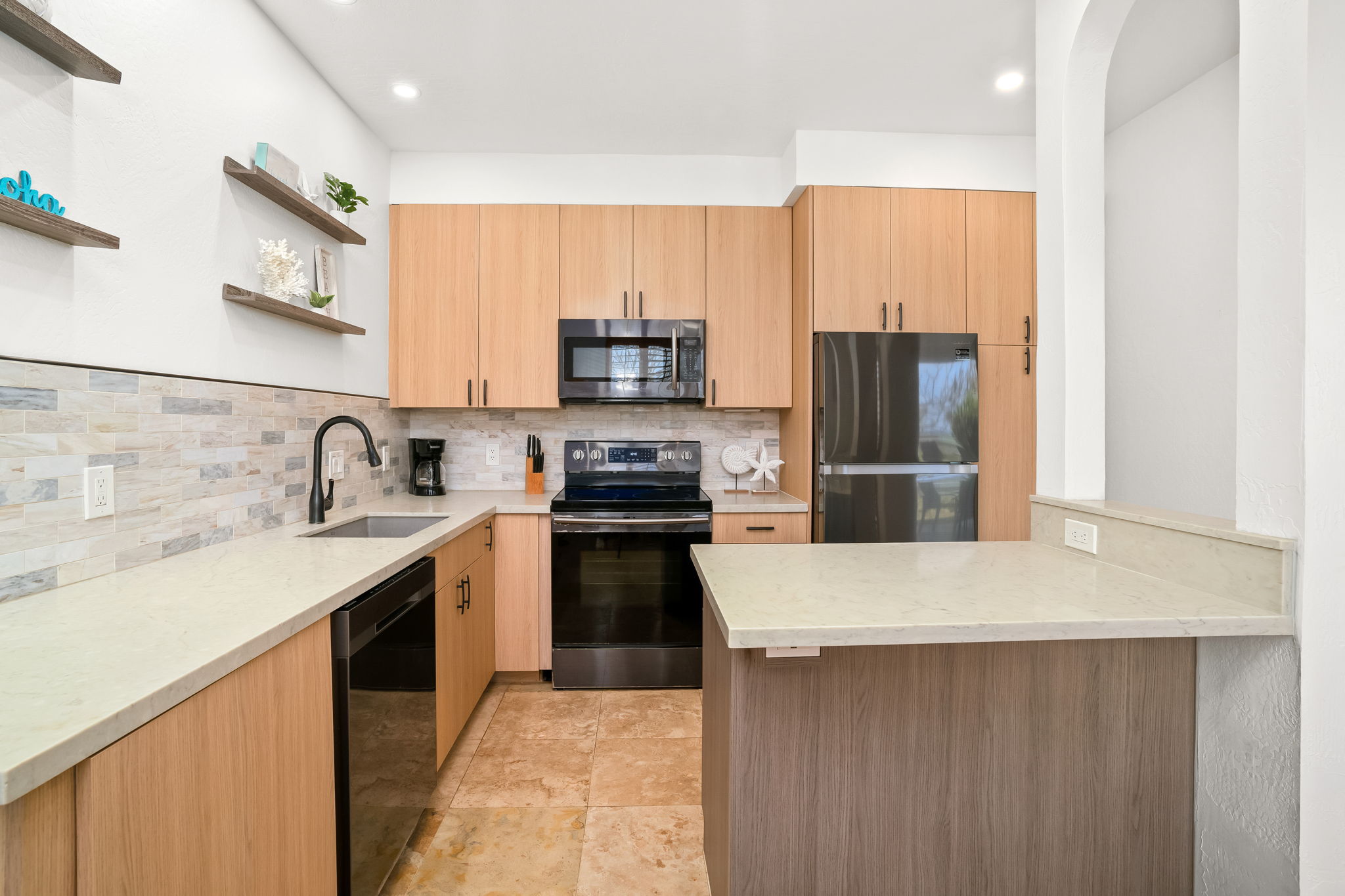 1901 Poipu Road, Unit 212 Koloa, HI 96756 - Photo 5 of 30 a kitchen with stainless steel appliances a refrigerator stove and sink