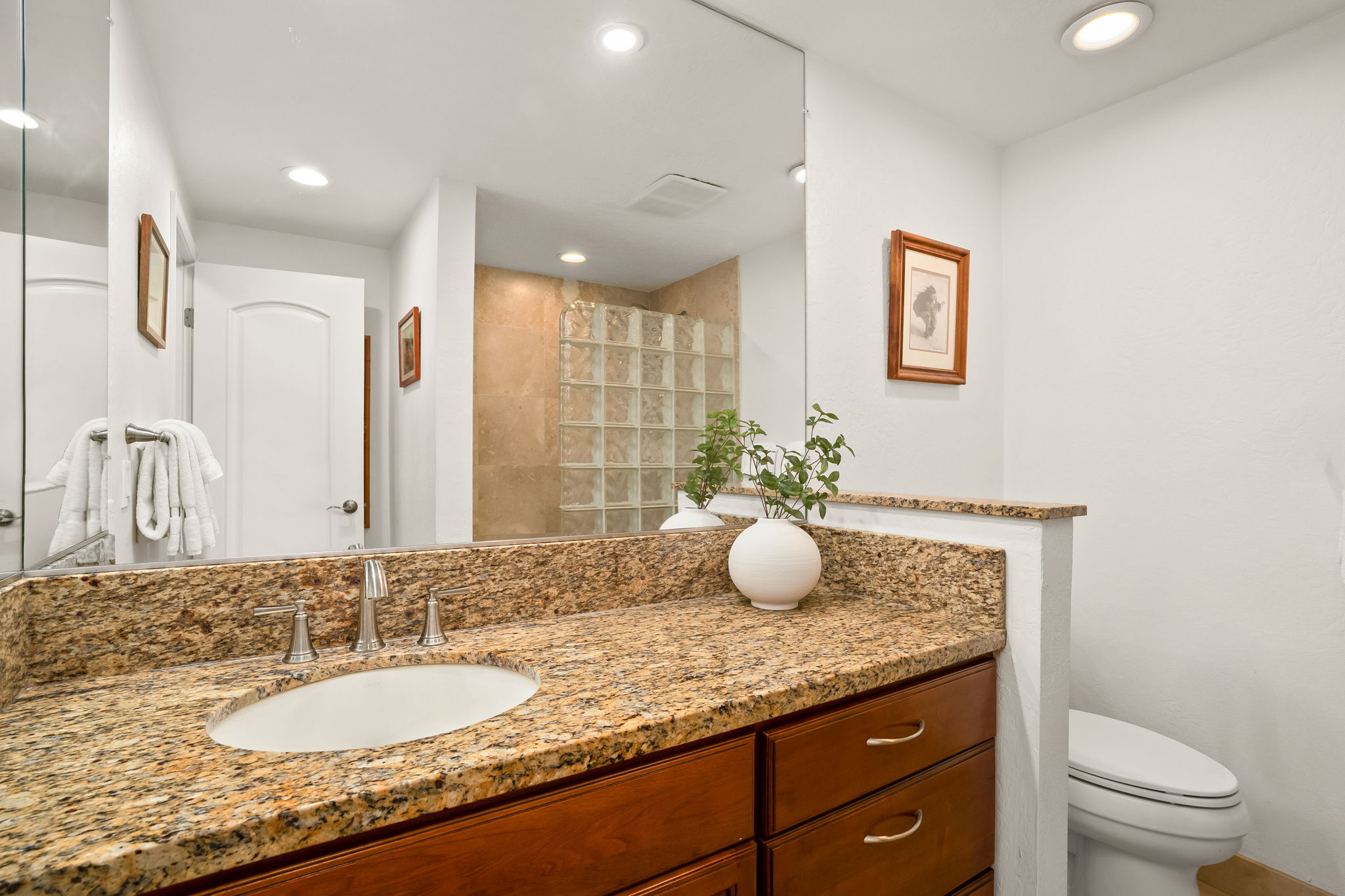 1901 Poipu Road, Unit 212 Koloa, HI 96756 - Photo 6 of 8 a bathroom with a granite countertop sink a toilet and a mirror