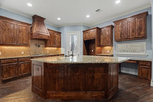 a kitchen with a sink stove and wooden cabinets