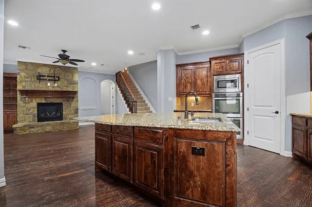 a kitchen with stainless steel appliances granite countertop a stove and a refrigerator