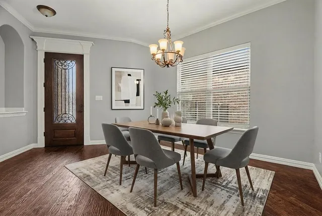 a view of a dining room with furniture wooden floor and a chandelier
