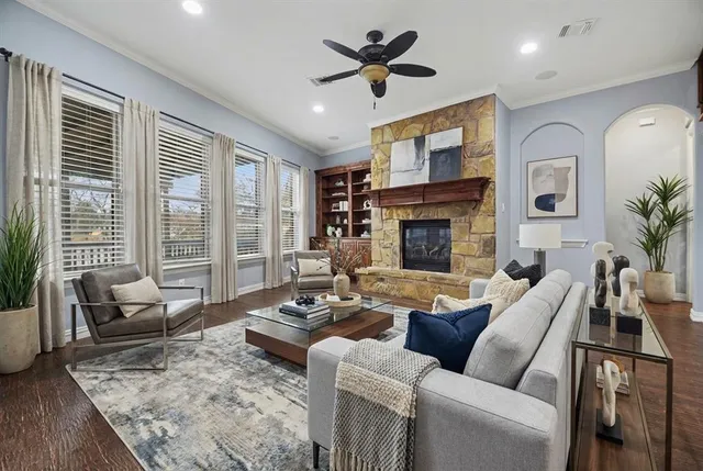 a living room with furniture fireplace and a large window