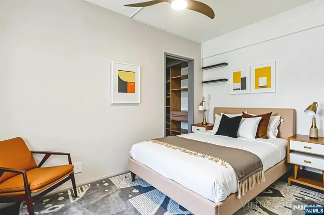 a bedroom with a bed and chair