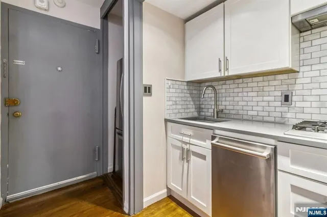 a stove top oven sitting inside of a kitchen