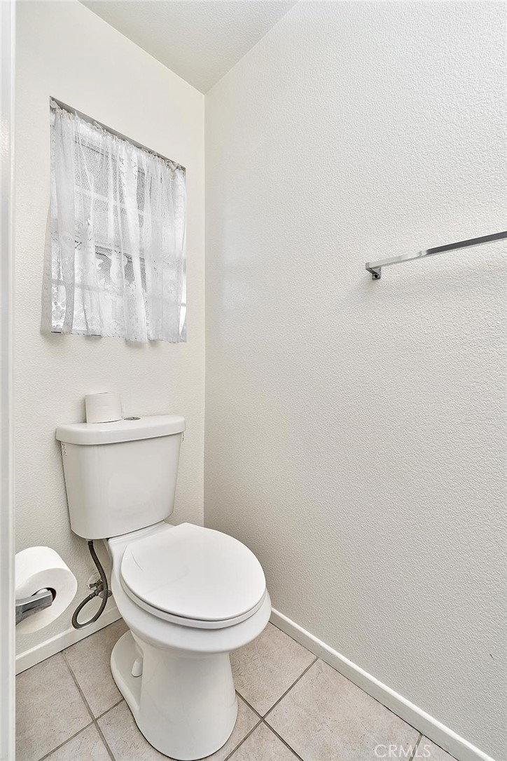 5280 Melbourne Place Riverside, CA 92508 - Photo 16 of 59 a white toilet sitting next to a bathroom sink
