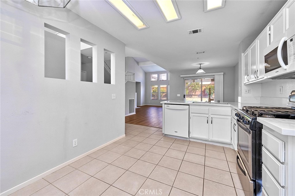 5280 Melbourne Place Riverside, CA 92508 - Photo 24 of 59 a kitchen with stainless steel appliances granite countertop a stove a sink and a refrigerator