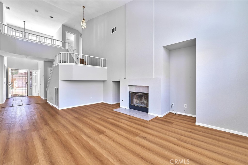 5280 Melbourne Place Riverside, CA 92508 - Photo 27 of 59 a view of empty room with wooden floor and fireplace