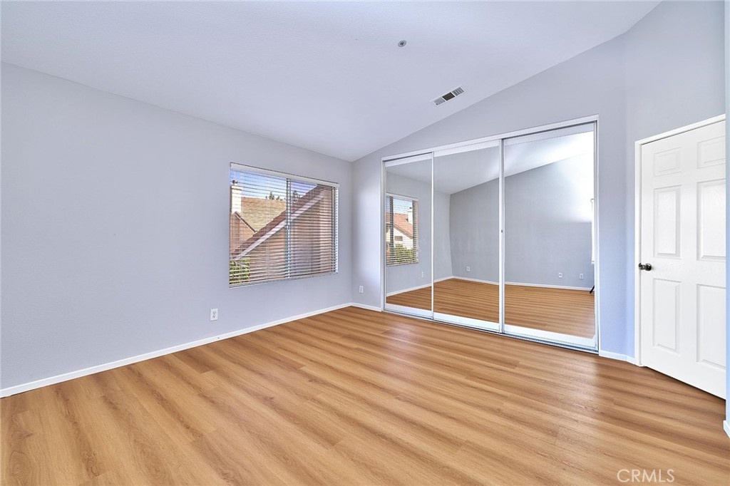 5280 Melbourne Place Riverside, CA 92508 - Photo 37 of 59 an empty room with wooden floor cabinet and windows