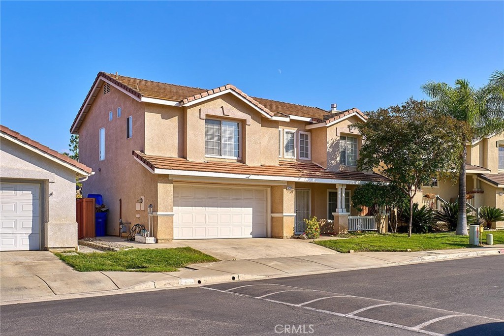 5280 Melbourne Place Riverside, CA 92508 - Photo 51 of 59 a front view of a house with a yard and garage