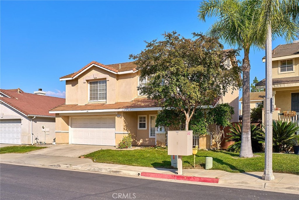 5280 Melbourne Place Riverside, CA 92508 - Photo 52 of 59 a front view of a house with a yard and garage