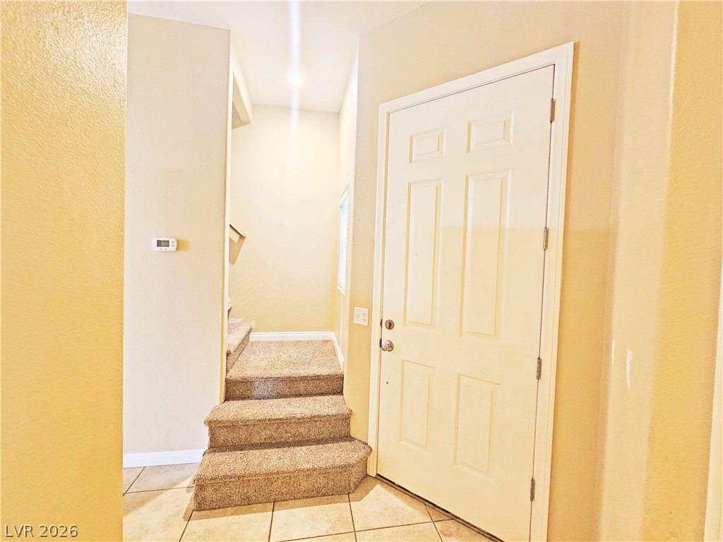 1421 Star Road, Unit 2 Pahrump, NV 89048 - Photo 3 of 33 Staircase featuring tile patterned floors and baseboards