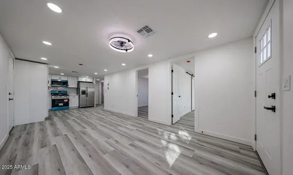 a view of an empty room with wooden floor