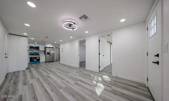a view of an empty room with wooden floor