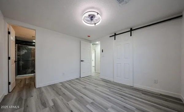 a view of a hallway with wooden floor