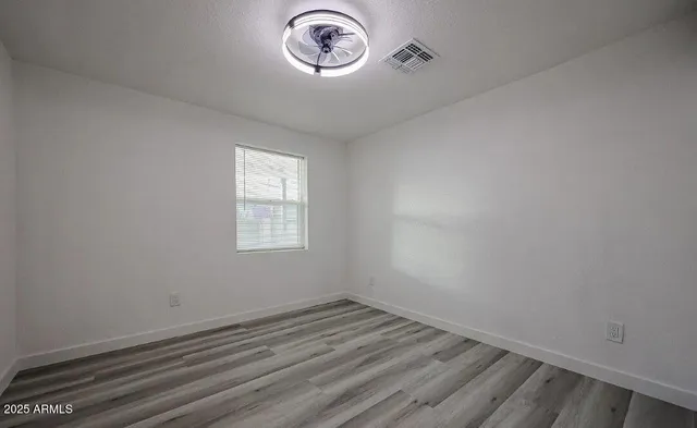 a view of a room with wooden floor and window