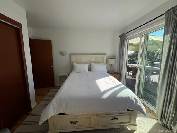 a bedroom with a bed and glass door