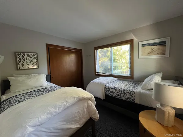 a bedroom with two beds and a window