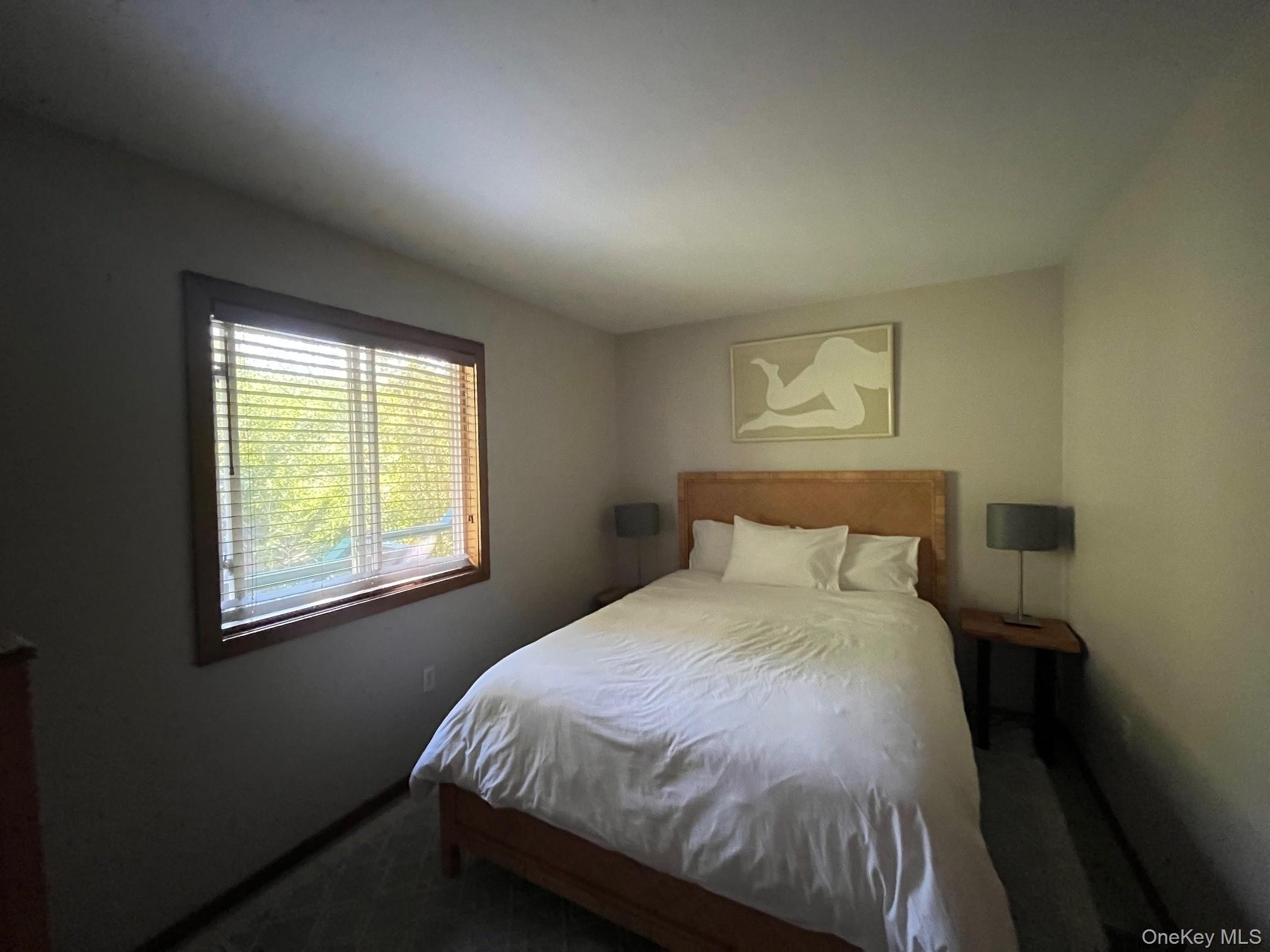 150 Clipper Way Ocean Beach, NY 11770 - Photo 13 of 27 a bed sitting in a bedroom next to a window