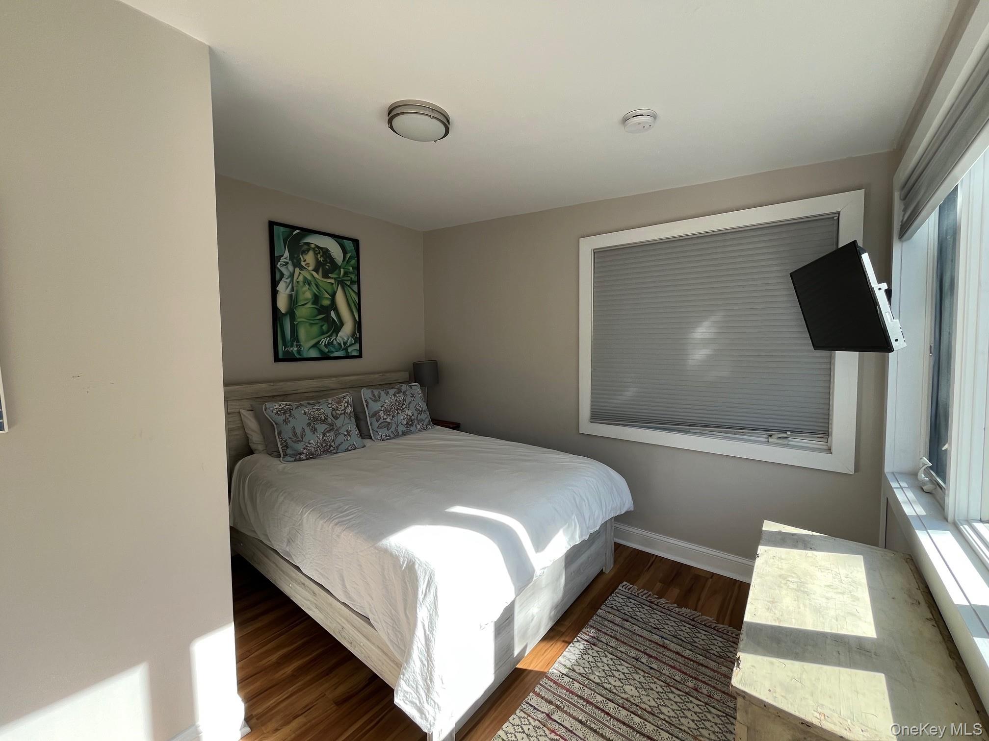 150 Clipper Way Ocean Beach, NY 11770 - Photo 14 of 27 a bed room with a bed and a large window