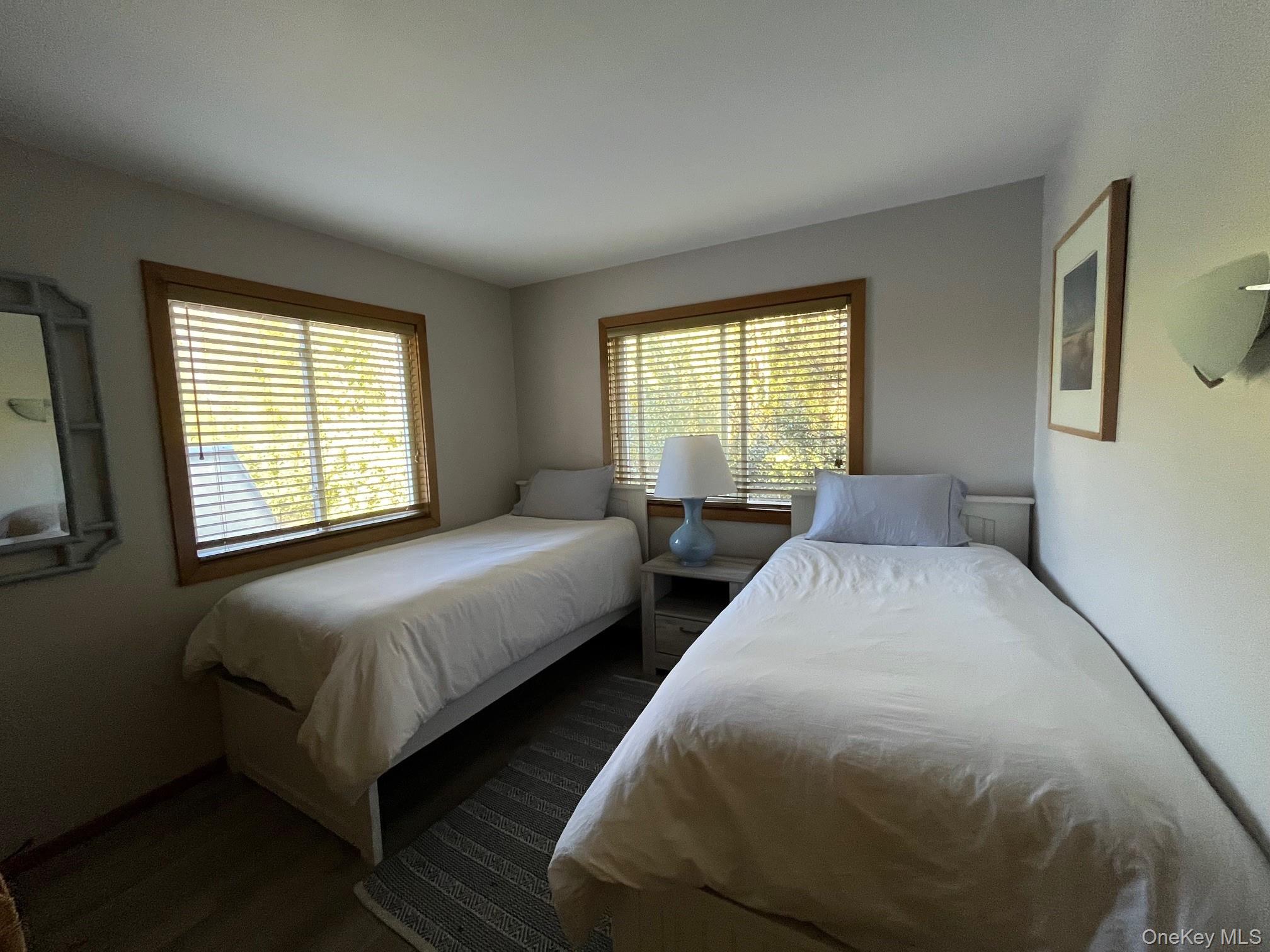 150 Clipper Way Ocean Beach, NY 11770 - Photo 15 of 27 a bedroom with two beds and a large window