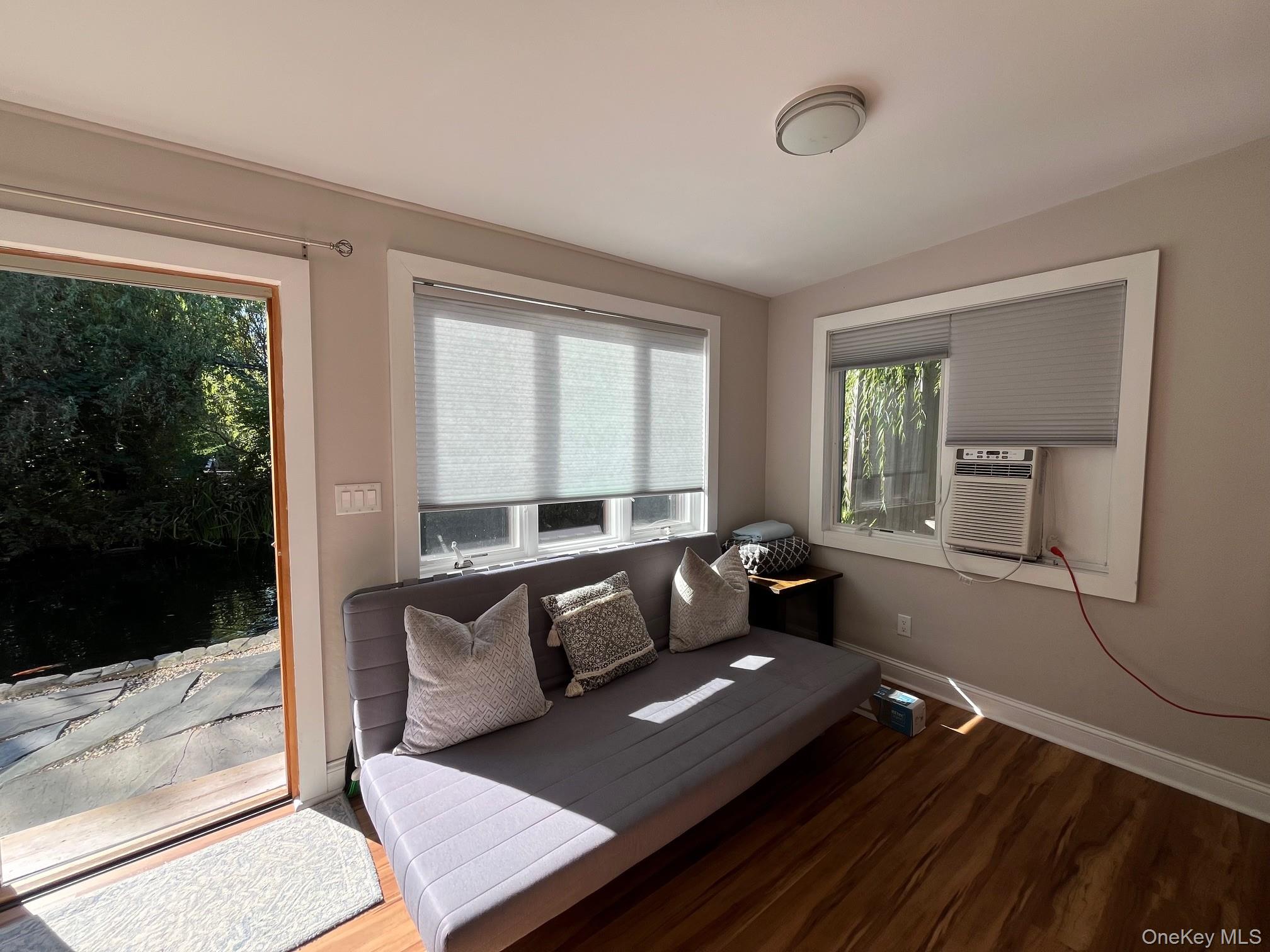 150 Clipper Way Ocean Beach, NY 11770 - Photo 18 of 27 a living room with furniture and a floor to ceiling window
