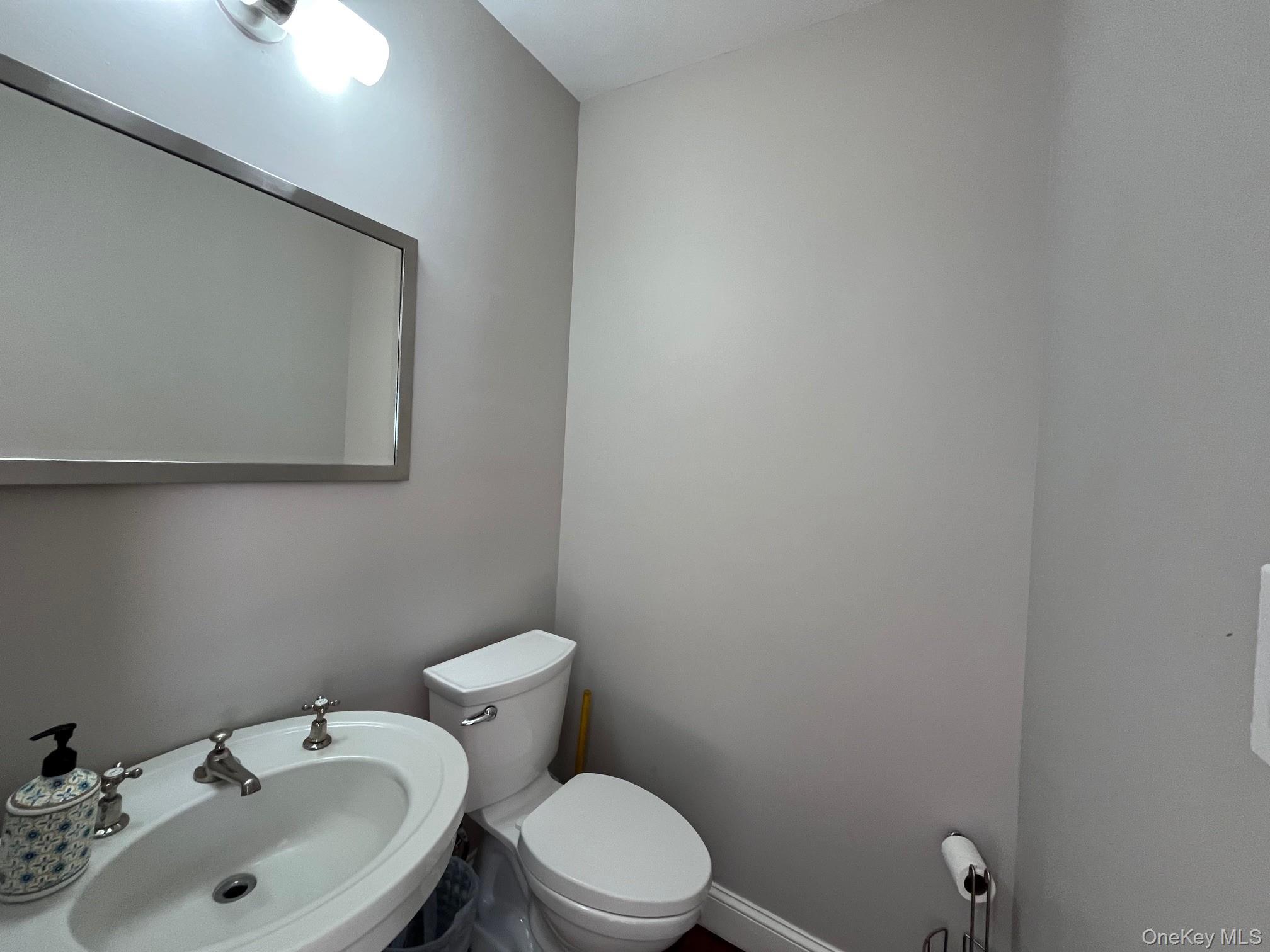 150 Clipper Way Ocean Beach, NY 11770 - Photo 19 of 27 a bathroom with a sink a toilet and mirror