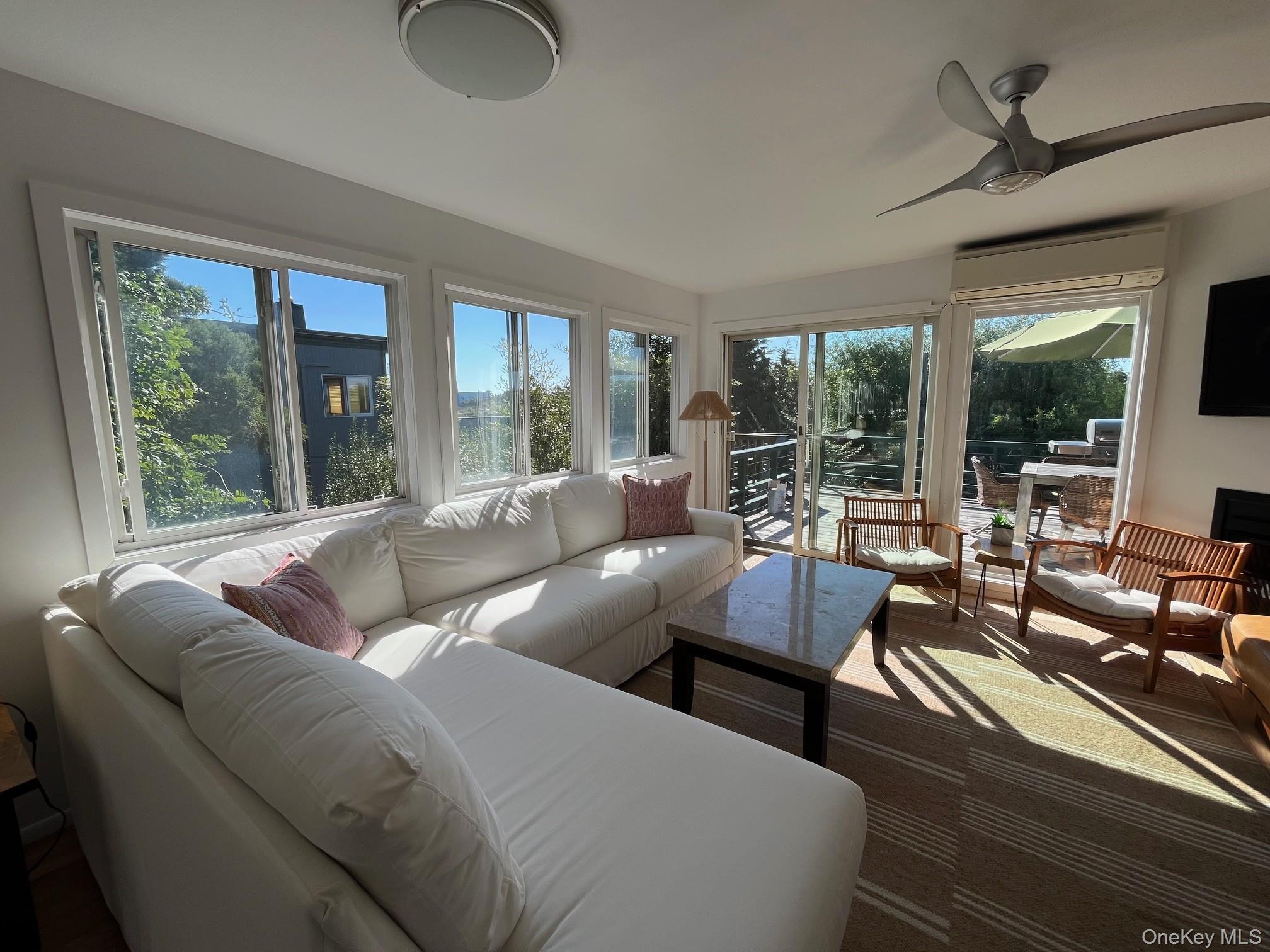 150 Clipper Way Ocean Beach, NY 11770 - Photo 2 of 27 a living room with furniture and a large window