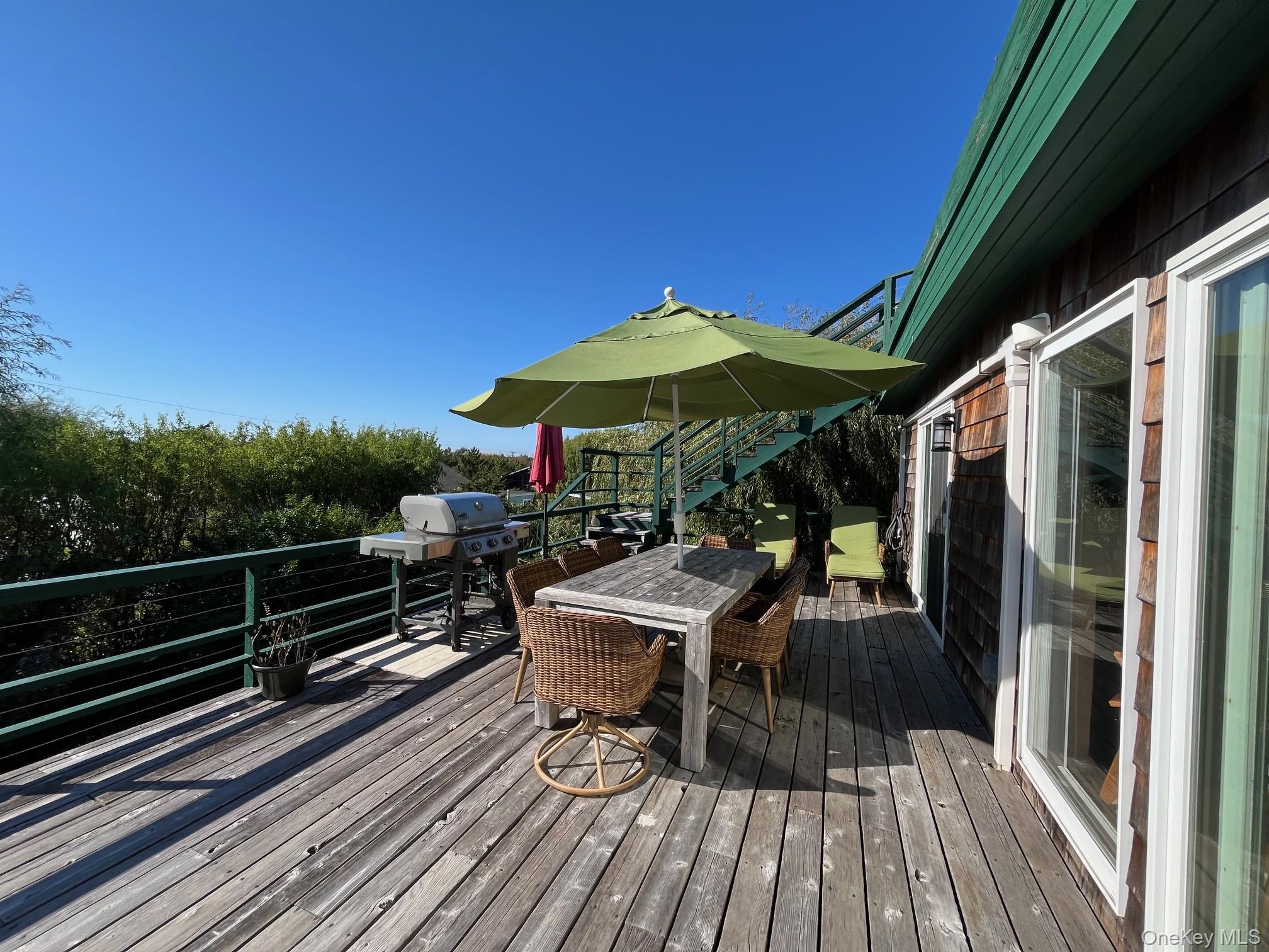 150 Clipper Way Ocean Beach, NY 11770 - Photo 22 of 27 a view of balcony with chairs and wooden floor