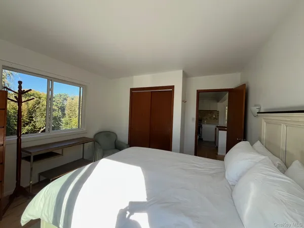 a bedroom with a bed and a large window