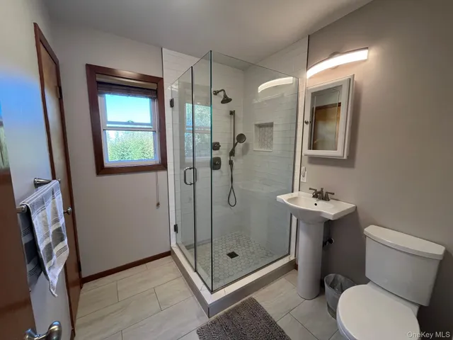 a bathroom with a toilet and a shower