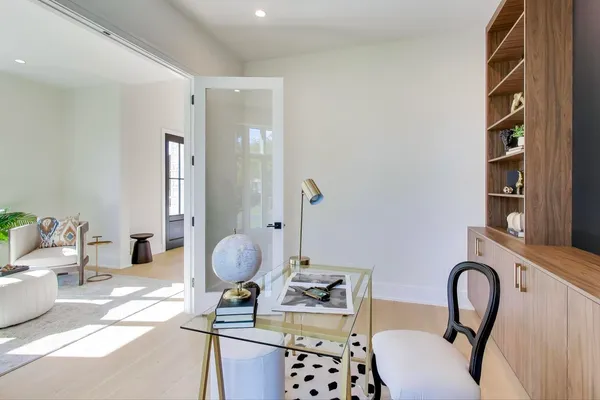 a kitchen with stainless steel appliances granite countertop a sink a stove and a wooden floors