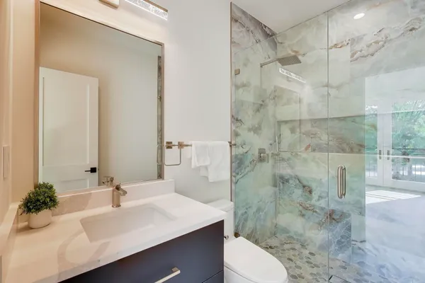 a bathroom with double sink and a mirror