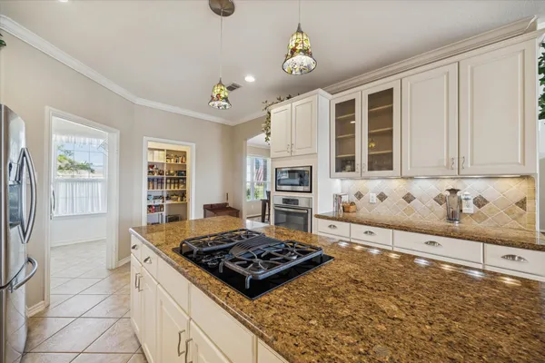 a kitchen with a stove and a sink