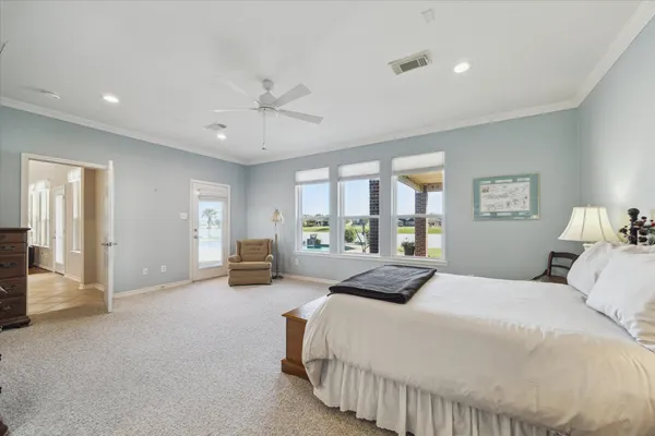 a bedroom with a large bed and a large window