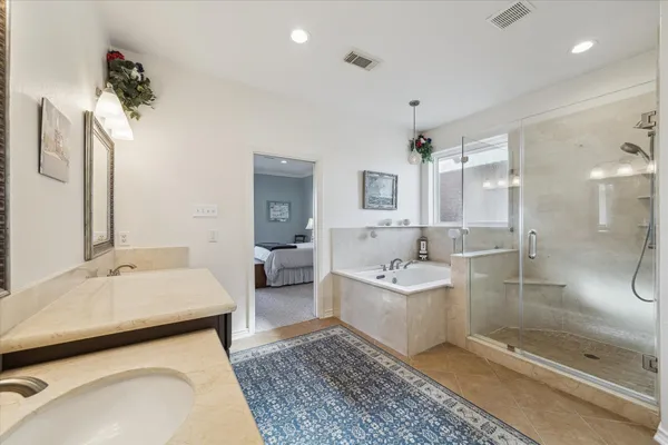 a spacious bathroom with a bathtub shower and sink