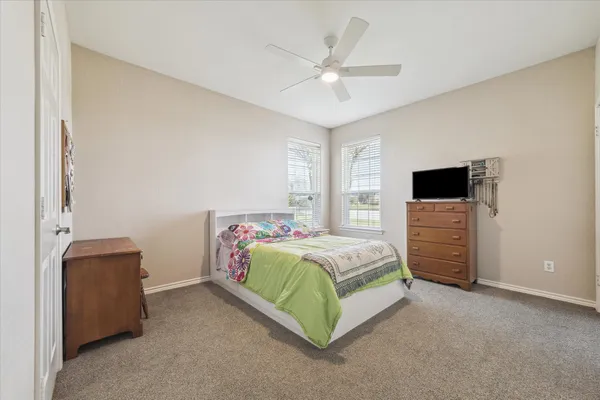 a bedroom with a bed and a television