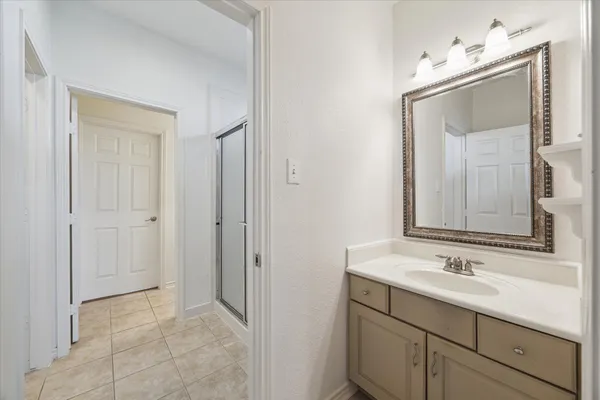 a bathroom with a sink vanity and mirror