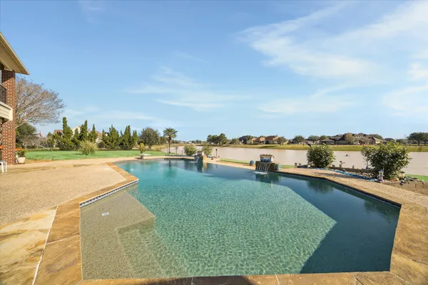 a view of swimming pool with outdoor seating and plants