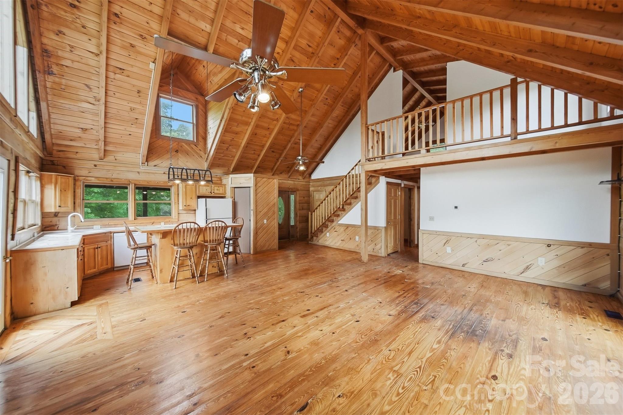 2079 Icard Ridge Road Taylorsville, NC 28681 - Photo 11 of 48 a view of a patio with table and chairs with wooden floor