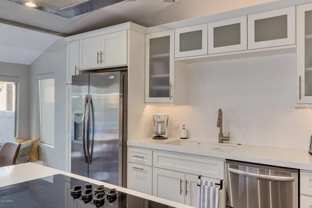 a kitchen with stainless steel appliances a refrigerator and a sink