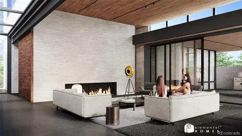 a living room with couches and a fireplace with garden view