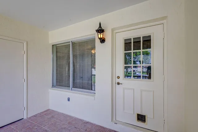 a view of an empty room with a window and bathroom