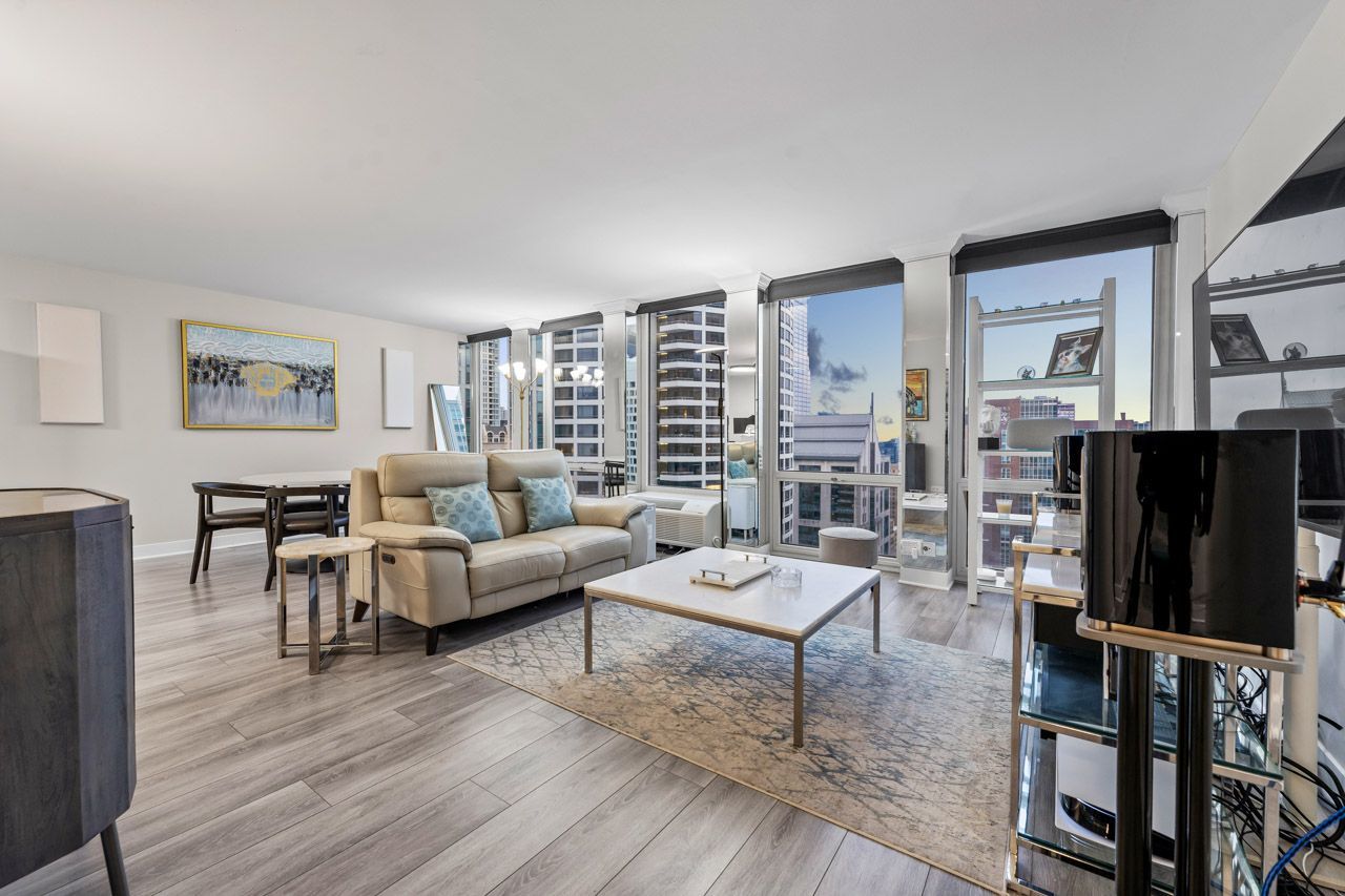 111 East Chestnut Street, Unit 28J Chicago, IL 60611 - Photo 3 of 36 a living room with furniture and a flat screen tv