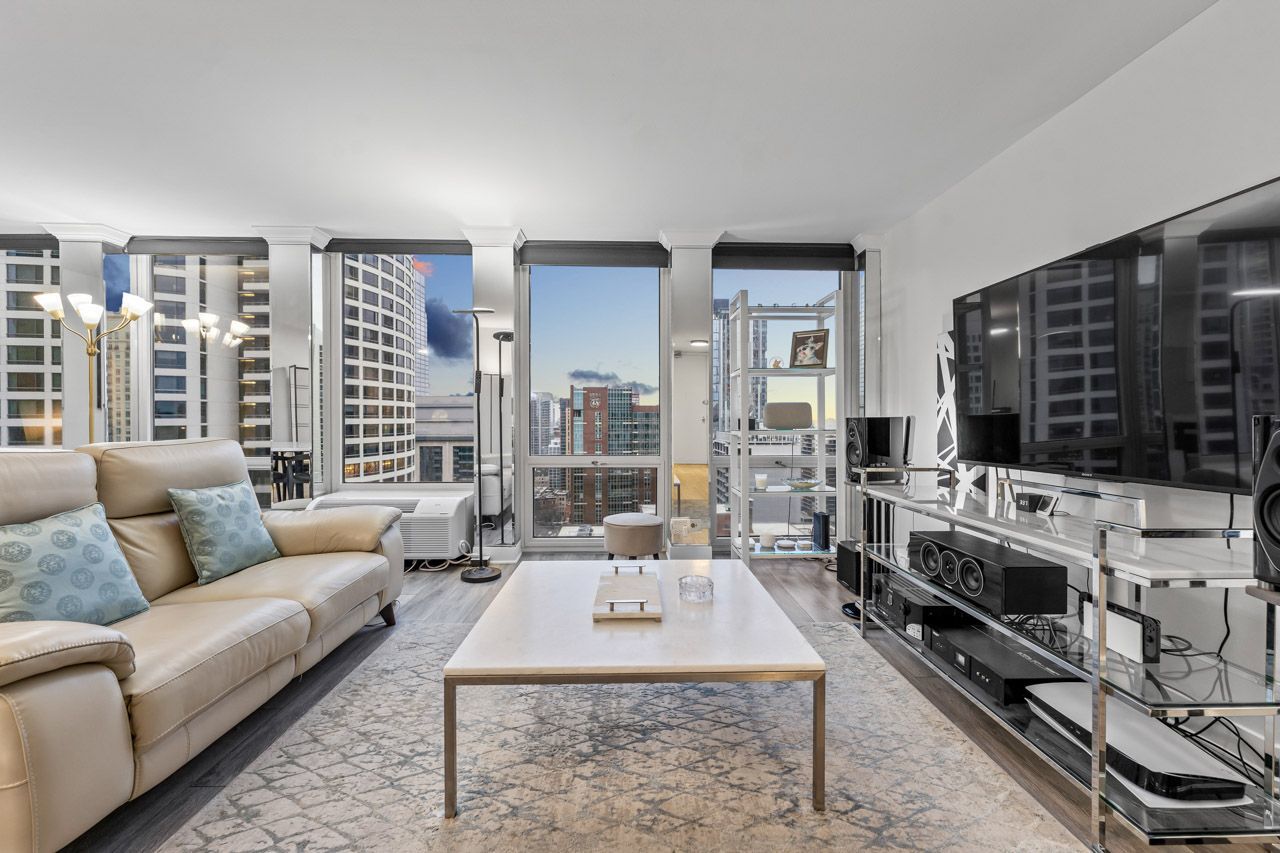 111 East Chestnut Street, Unit 28J Chicago, IL 60611 - Photo 4 of 36 a living room with furniture large window and a flat screen tv